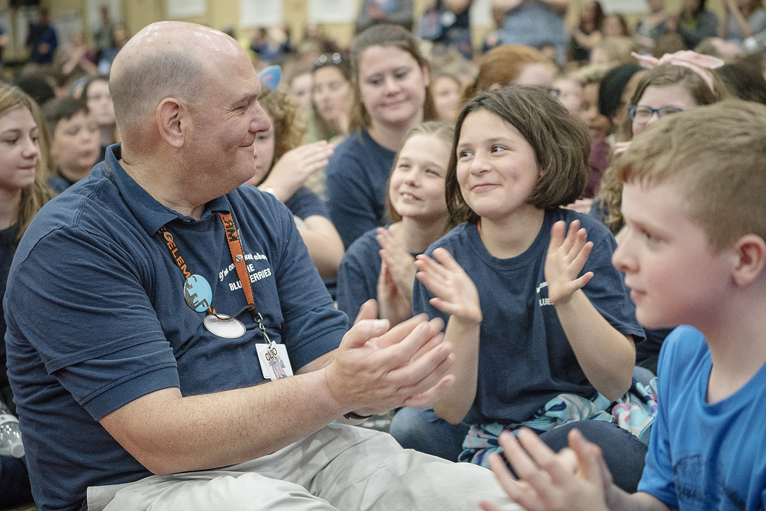 Flint, MI - Friday, May 4, 2018: Students from Garner Elementary in Clio applaud and admire elementary counselor David Griffel (left) as Blueberry Ambassadors were encouraged to recognize their teachers and mentors that accompanied them to the 5th An