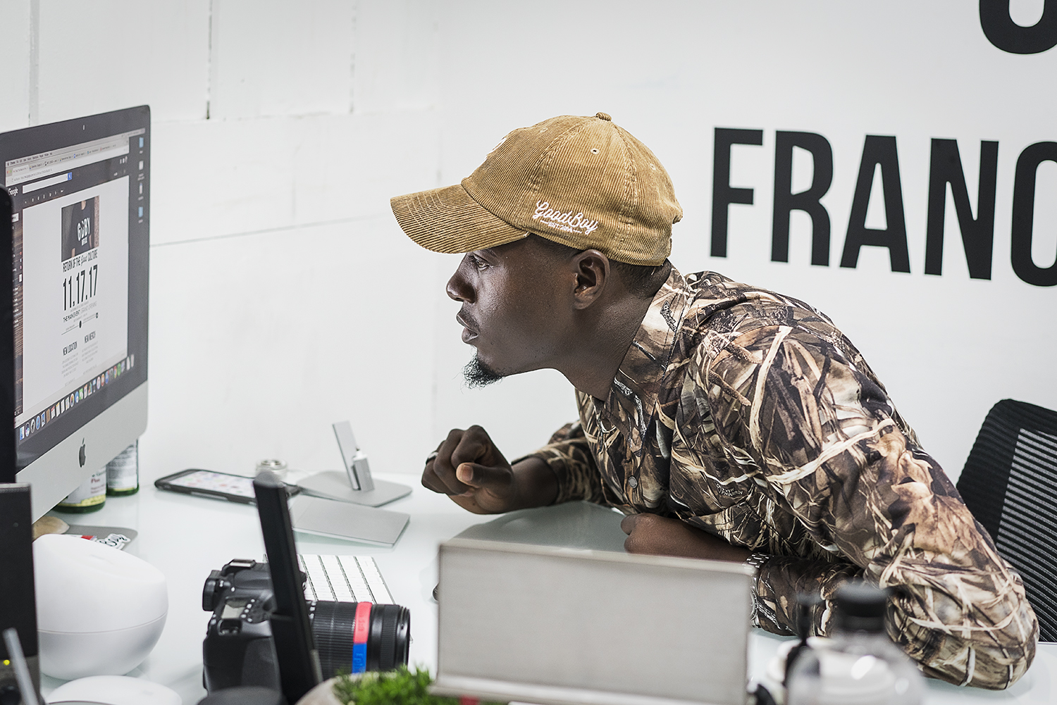 Operations Manager for GoodBoy Clothing Mark Chatman, 27, of Flint, proofreads the website, ensuring that it is ready for the launch of the new storefront in downtown Flint. 