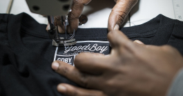 GoodBoy Clothing textile expert Tameka Davis, 37, of Flint, stitches tags into new shirts that are headed to the showroom at the new GoodBoy Clothing storefront in downtown Flint.