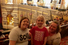 Isla Hayes with UM-Flint ECDC teachers Jen Cozart (left) and Jessica Matusz during Double Dare Live at the Fox Theatre in Detroit. 