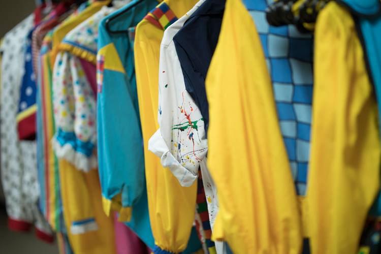 The costumes are lined up and ready for the 11-member clown troop known as the Mott Campus Clowns, which delivers an anti-bullying message in its performances.