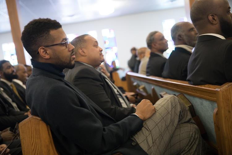 Isaiah Oliver sits with other members of the Alpha Phi Alpha fraternity at the MLK Day Youth Tribute, which includes performances by the Alpha Esquires.