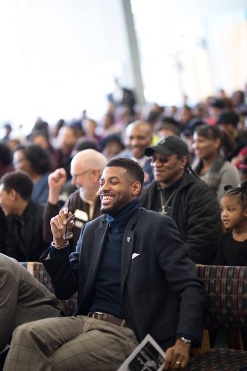Isaiah Oliver laughs at a joke from U.S. Rep. Dan Kildee during the MLK Day celebration at Flint Public Library.