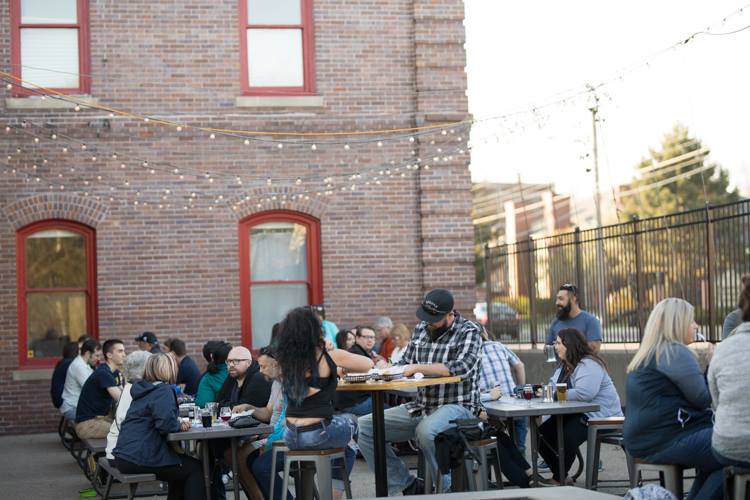 A crowd fills the patio on a recent trivia night at Tenacity Brewing, which like other downtown Flint bars is pairing its standard taps with unique events.