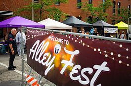 Hundreds of people gather in downtown Flint's Buckham Alley for Alley Fest, an annual event hosted by nonprofit Friends of the Alley featuring live music, food, and vendors, on Saturday, July 8, 2023.