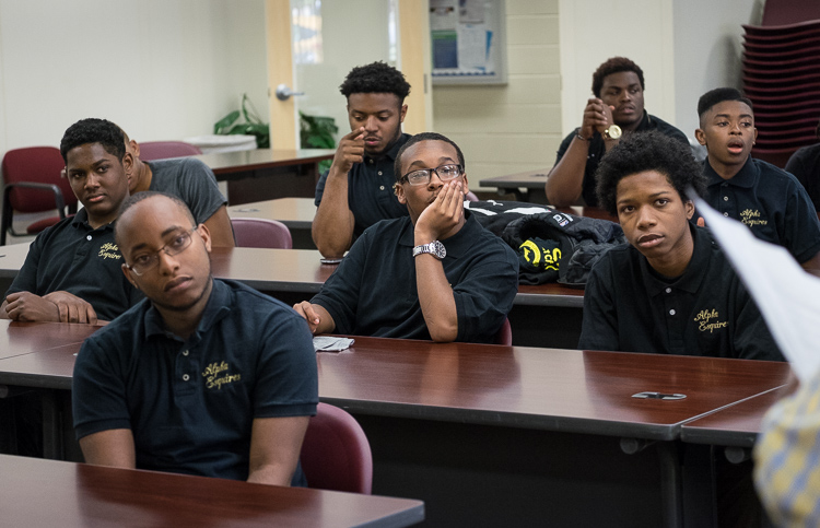 The young men of Alpha Esquires listen during the group's weekly meeting at Mott Community College Workforce Center on North Saginaw Street in Flint.