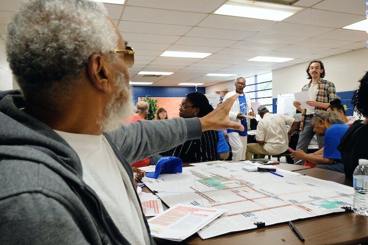 Civic Park resident Arthur Port, 77, raises a concern about overgrown corner lots to City of Flint urban designer Michael Lawlor at a Neighborhood Planning Workshop.