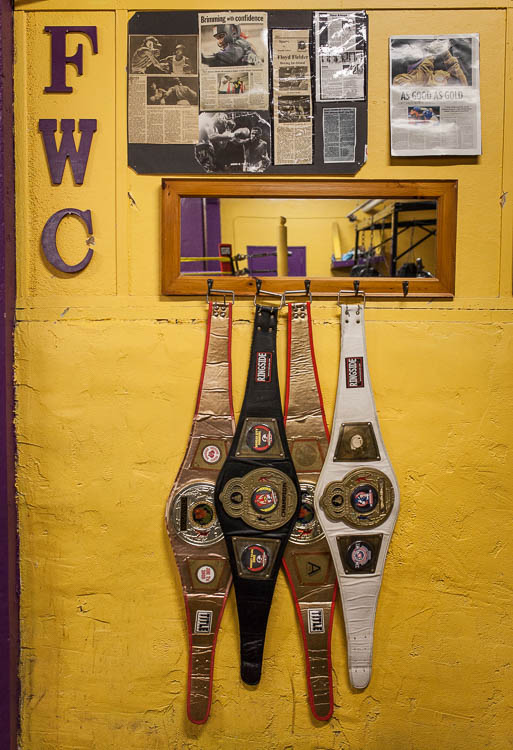 Championship belts belonging to current Berston boxers hang in the boxing gym in Flint.