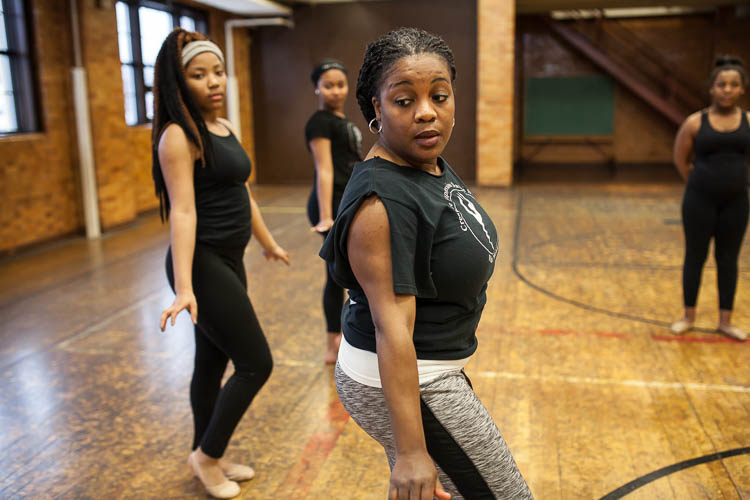 Instructor Jamise Wash-Lang demonstrates part of a routine to her Creative Expressions Dance Studio students at Berston Field House in Flint. The dancer at left is Janiyah Fells, 12, of Flint.