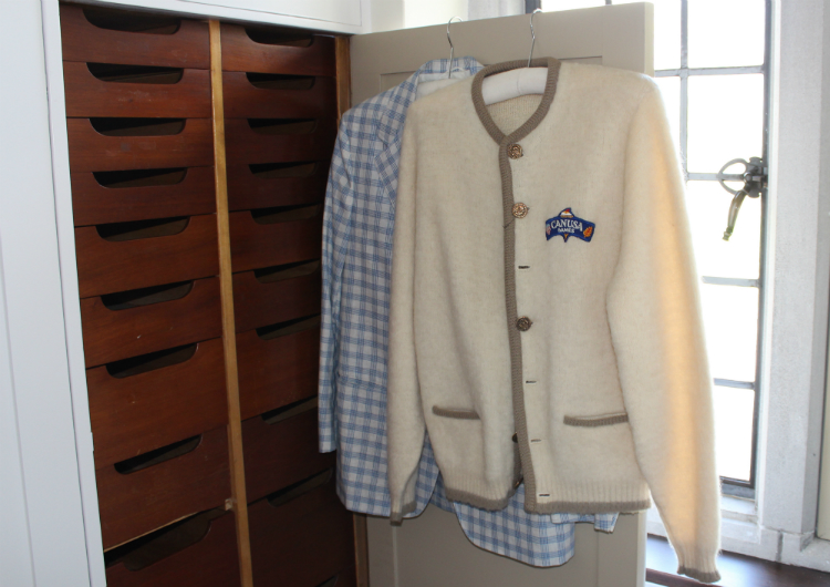 Charles Stewart Mott's closet features a flamboyant collection of clothes—including this CANUSA Games sweater and plaid blazer.