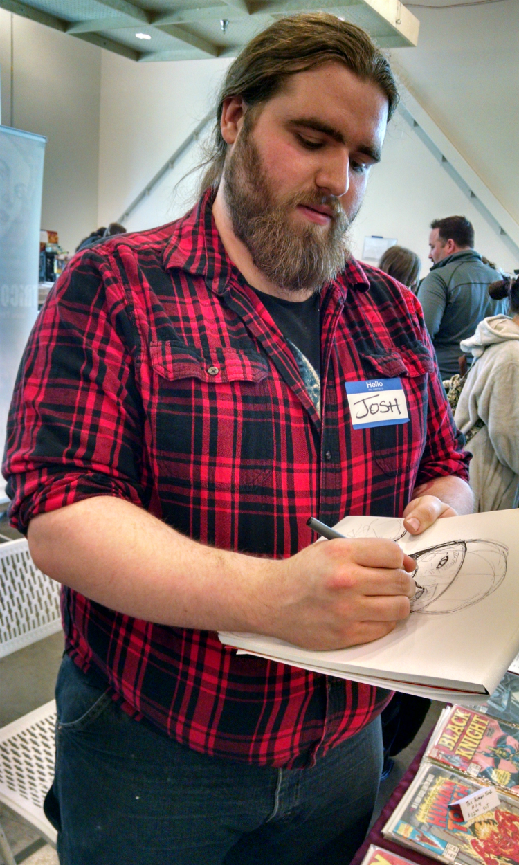 A sketch artist at the Flint Comix Con in the spring at the Flint Farmers' Market.