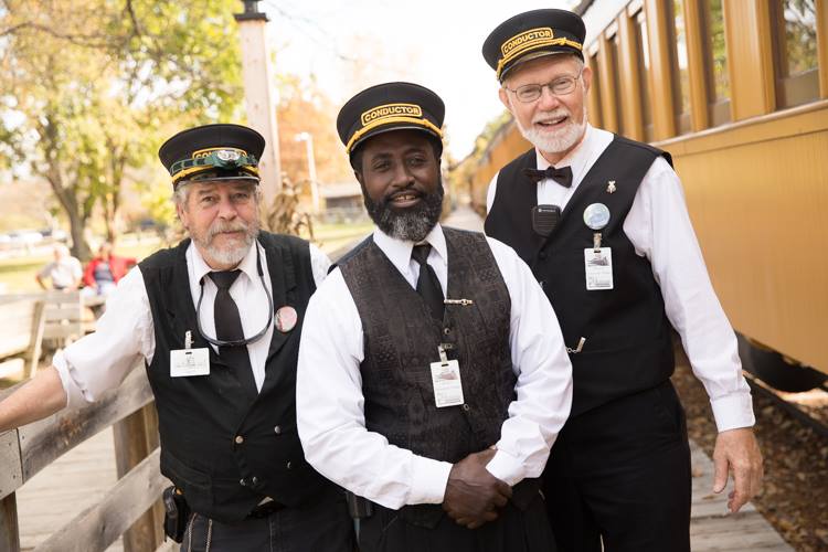 Larry Coleman poses with Guy Baumgart and Lewis Young, his fellow conductors at the Huckleberry Railroad. Operating the train takes a staff including brakemen, firemen (who shovel coal to keep the steam engine running), conductors and engineers.