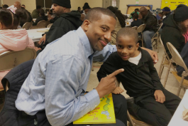 Derrick Munson poses with his son Brandon, 6, during Donuts with Dad at Durant-Tuuri-Mott Elementary School in Flint.