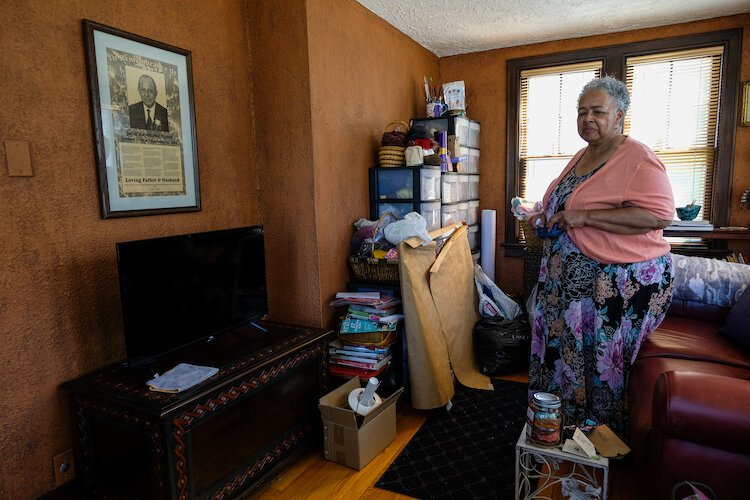 aynetta Speed, 69, stands in her childhood music room where she took piano lessons. It's now her knitting room and also the place where her father's memorial, "In Remembrance of John R. Speed," hangs (pictured left).