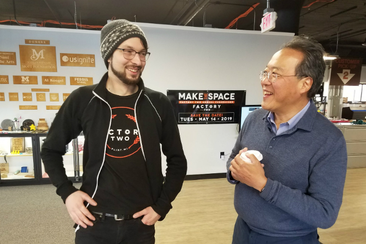 Jon Hardman gives Yo-Yo Ma a tour of the Factory Two makerspace during the cellist's visit to Flint on Feb. 28. 