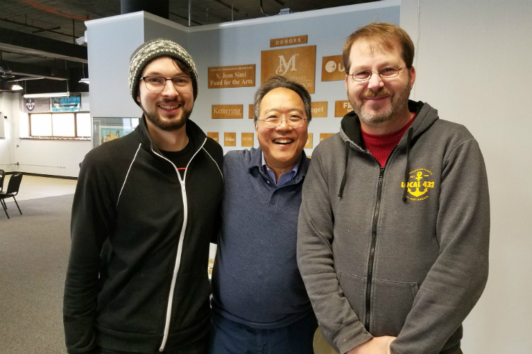 Yo-Yo Ma poses for a photo with Jon Hardman and Joel Rash at Factory Two in Flint.