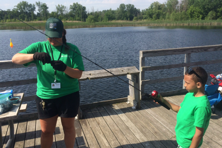 Alison Clemons of Genesee County Parks even helps participants get their hook baited during the Kids Fishing Club events. 