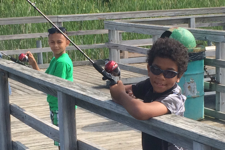 Camron (left) and Javon participated in the first Kids Fishing Club hosted by the Genesee County Parks this summer. Eight others are scheduled in Flint and Clio.