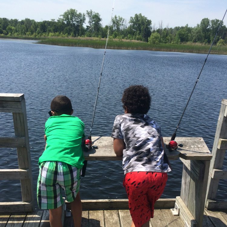 The boys wait, as patiently as possible, for a bite during the Kids Fishing Club event at Buell Lake this month. 