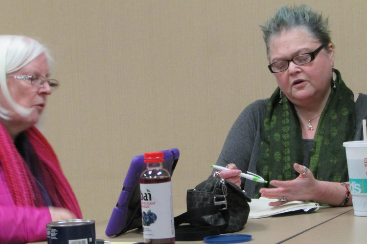 Offering encouraging words and critique, Nancy Tucker (left) Martha "Mart" Allard participate in a recent Flint Area Writers meeting.