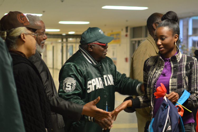 Greeters line up at Flint Northwestern High School to give support and encouragement to students as they arrive for school. 