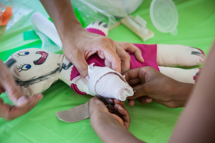 A doll is available to bandage and pretend to listen to a heart beat at the 8th Annual Miracle Picnic at the Sloan Museum on Tuesday.