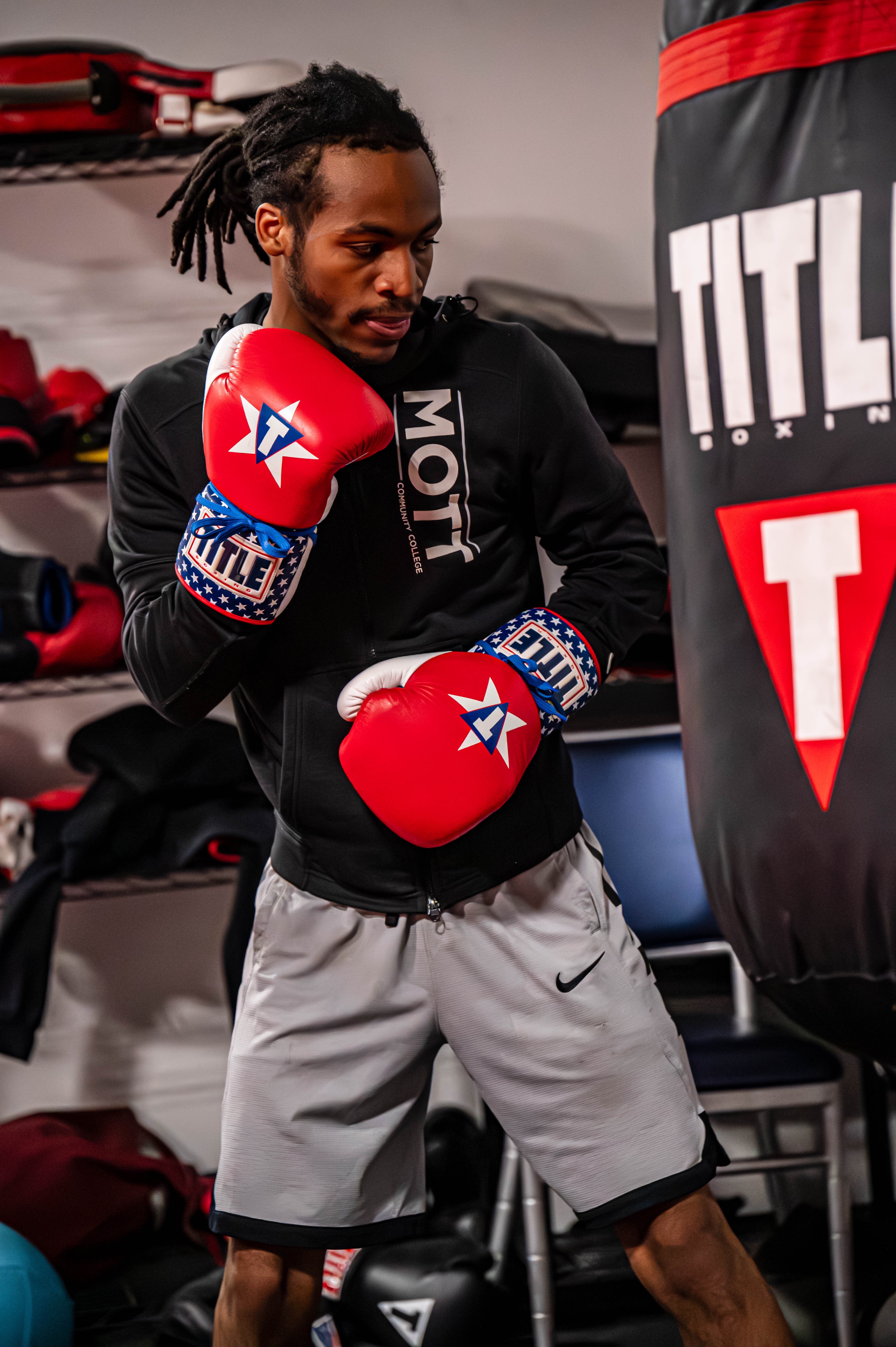 Jaylyn Nichols spars for conditioning with a punching heavy bag in 3-minute simulated rounds to prepare for the fight.