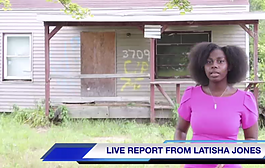 Flint native Latisha Jones standing in front of her childhood home.