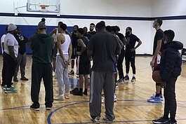 Kevin Mays (left, grey hat) talks with players trying out for Flint United during a training camp in January 2021.