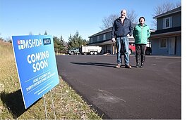 Yarrow Brown, executive director of Housing North, and Jon Stimson, executive director of HomeStretch Housing, outside of Vineyard View Apartments in Suttons Bay.