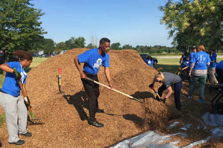 Flint City Councilman Eric Mays was among the volunteers helping to spread mulch at the new playground at Hasselbring Senior Center.