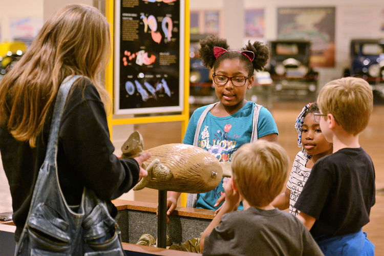 Museum-goers look at the platypus exhibit at The Robot Zoo in the Sloan Museum at Courtland Center. 