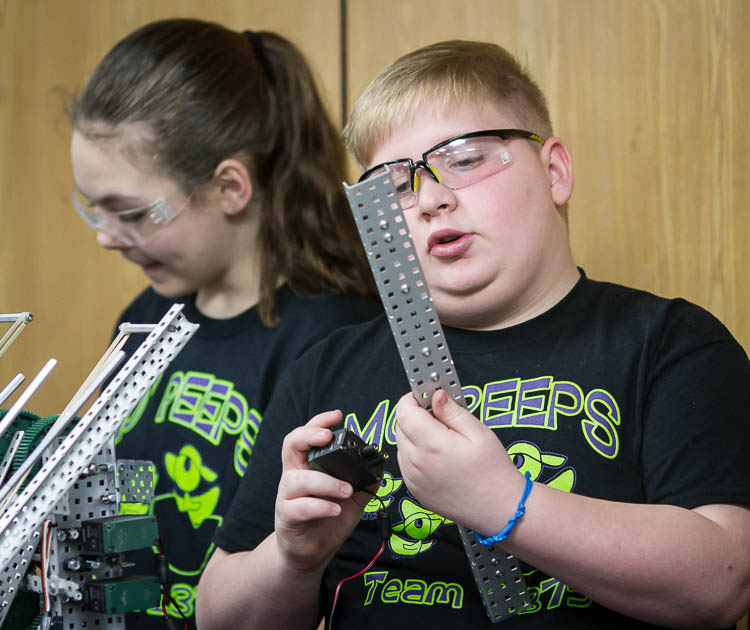 Max Johnson, 11, a student at Rankin Elementary works on a building a robot during a demonstration of the robots team skills at Woodland Elementary.