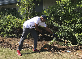 Resident Antoine Little working during a cleanup in the Sarvis Park area in Flint.