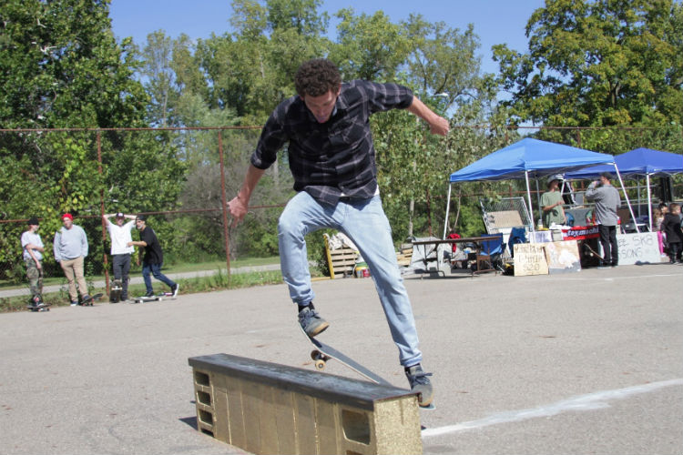 Jon May hits the rail during the benefit for the Flint Skate Park.