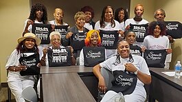 The ladies of the line dancing group Smooth Steppers pose proudly with their 'Smooth Steppers' totes and “I Am My Sister’s Keeper” tees.