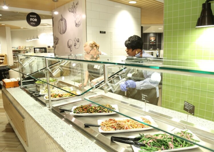Staff serves up food at Corewell Health's The Green Beet.