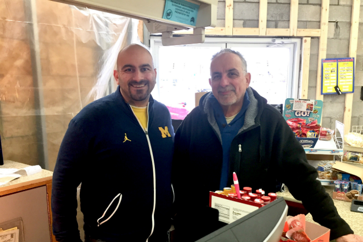 The Fanous family continues to invest in Flint—and is now rebuilding after a car plowed into their business. Shown here is Elias, who owns University Market, and his father George, who often works there.