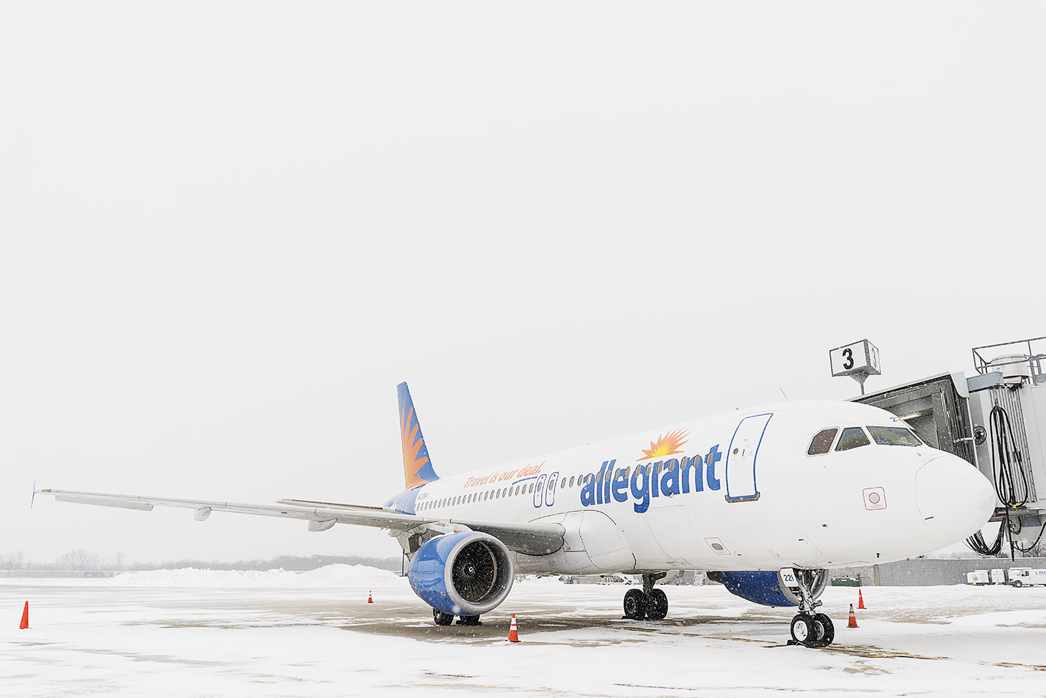An airplane, part of the Allegiant fleet, waits on the tarmac to be boarded and loaded with luggage at Bishop International Airport.
