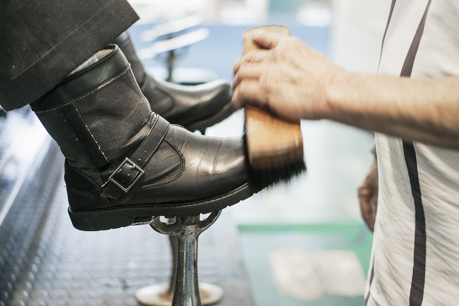 Flint, MI - Friday, January 26, 2018: Joe Garza, 69, of Mt. Morris shines a customer's shoes at the shoe shine stand at Bishop International Airport.