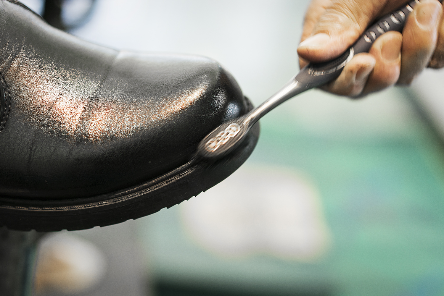 Flint, MI - Friday, January 26, 2018: Joe Garza, 69, of Mt. Morris shines a customer's shoes at the shoe shine stand at Bishop International Airport.