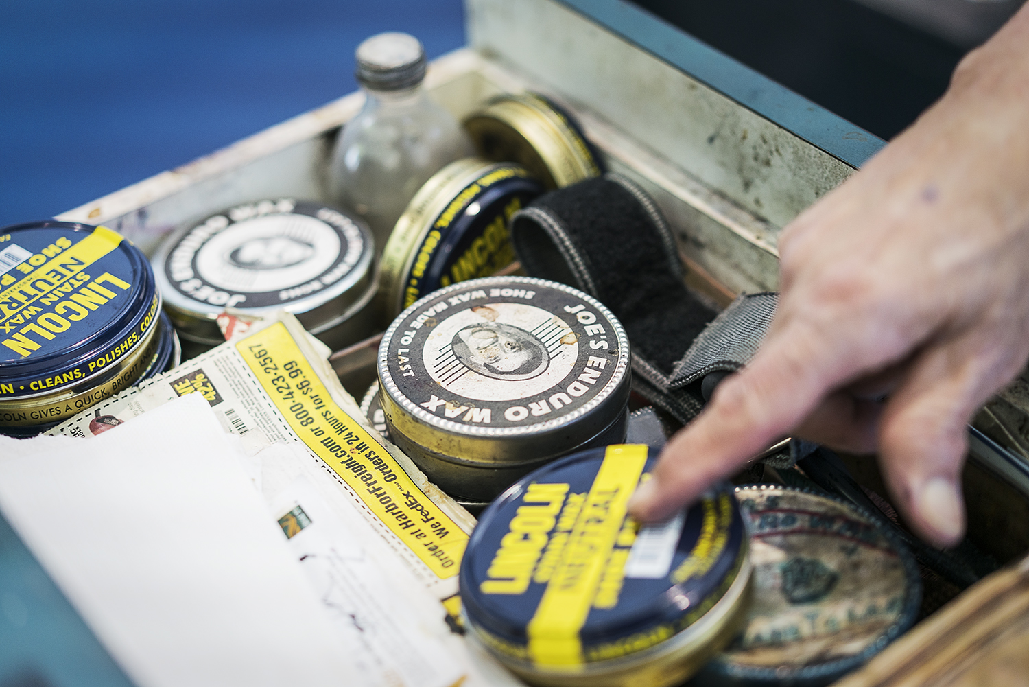 Flint, MI - Friday, January 26, 2018: Mt. Morris resident Joe Garza, 69, goes through his drawer of shoe polish at the shoe shine stand at Bishop International Airport, where he has worked for 36 years. 