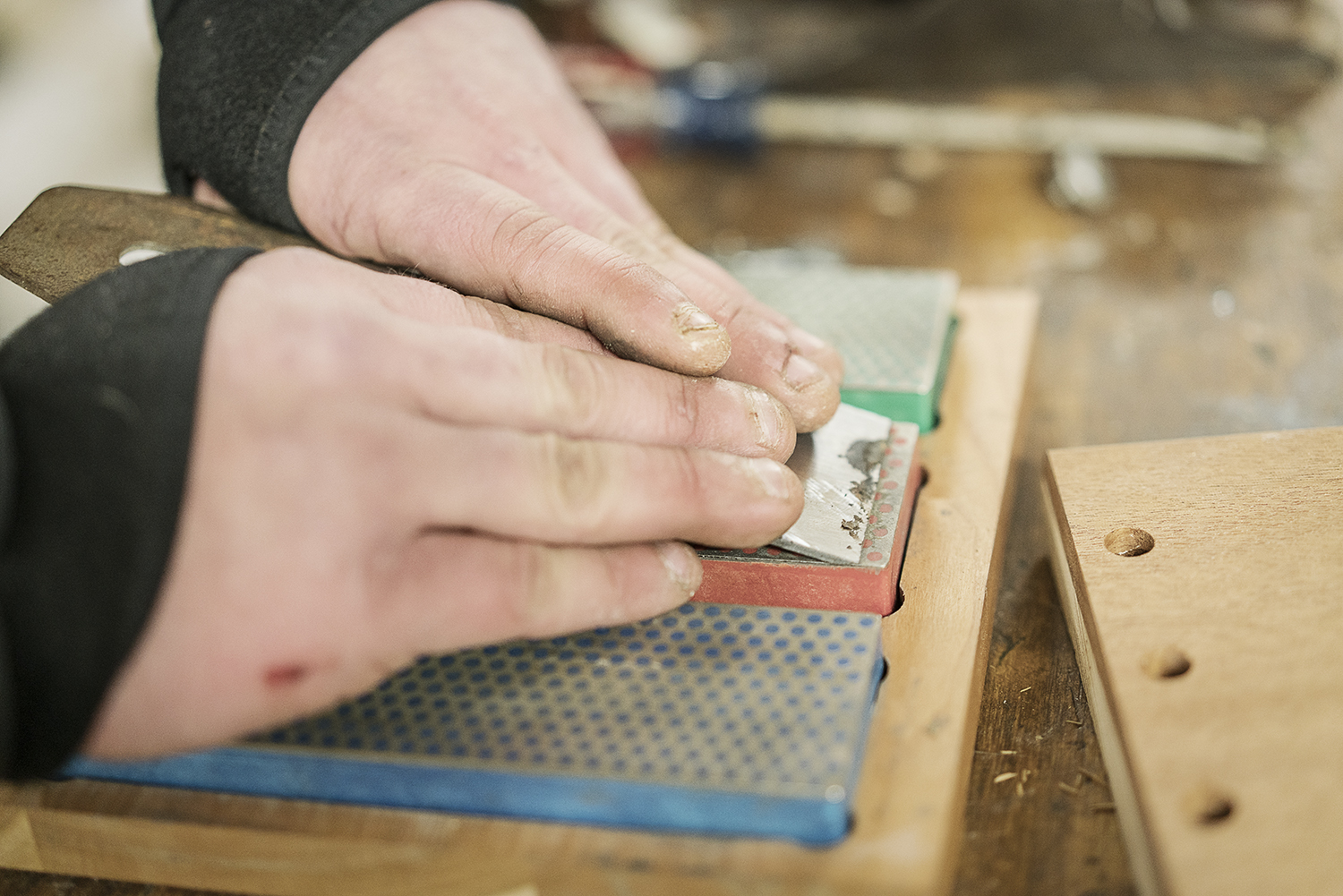 Flint, MI - Friday, February 2, 2018: Flint resident Michael Callahan sharpens the blade of a bench-plane on his workbench at Factory Two in Flint.