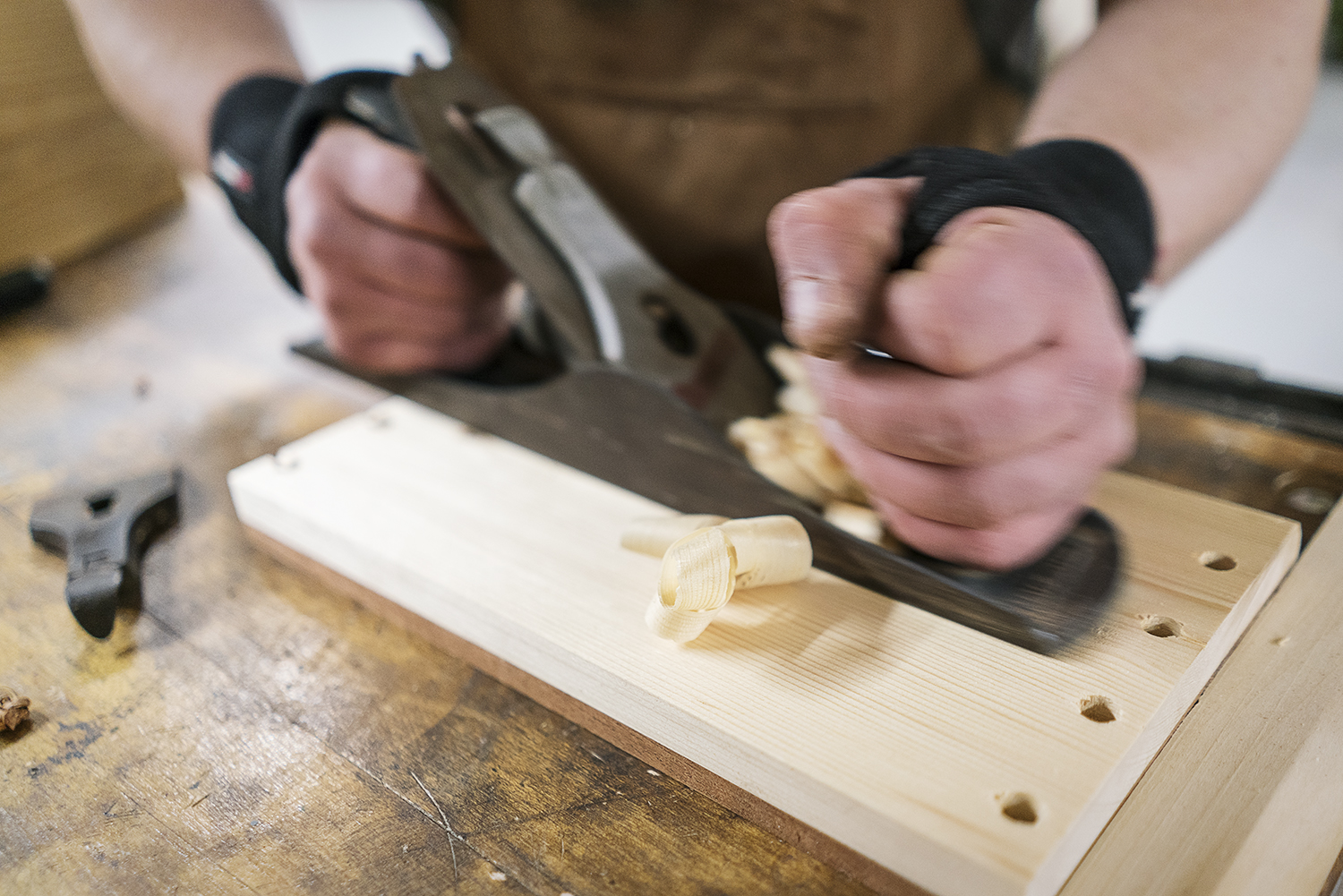 Flint, MI - Friday, February 2, 2018: Flint resident Michael Callahan planes and smooths down a panel for a cabinet he is building at Factory Two in Flint.