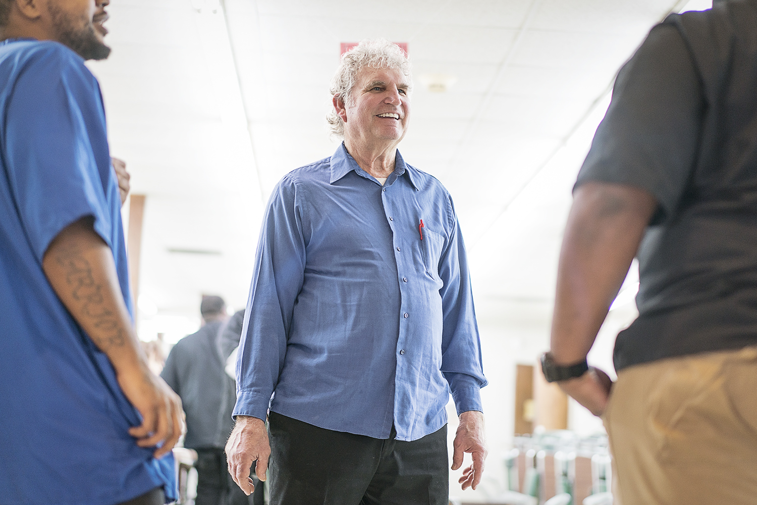 Flint, MI - Tuesday, February 6, 2018: Flint Institute of Barbering Director of Education Bob Morey, 68, from Linden, smiles as he speaks with customers.