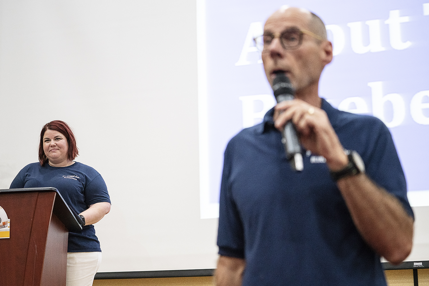 Flint, MI - Friday, May 4, 2018: FlintSide publisher and Flint resident Marjory Raymer, 44 (left) watches as Blueberry Founder and Fenton Twp. resident Phil Shaltz, 69, speaks to the Blueberry Ambassadors during the 5th Annual Blueberry Ambassador Aw
