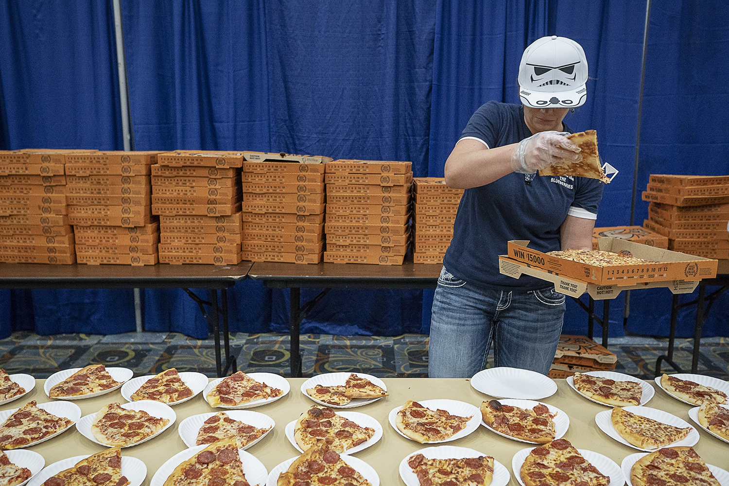Flint, MI - Friday, May 4, 2018: Swartz Creek resident Joy Nyman, 33, places slices of pizza on paper plates for incoming Blueberry Ambassadors at the Riverfront Banquet Center for the 5th Annual Blueberry Ambassador Awards Party.