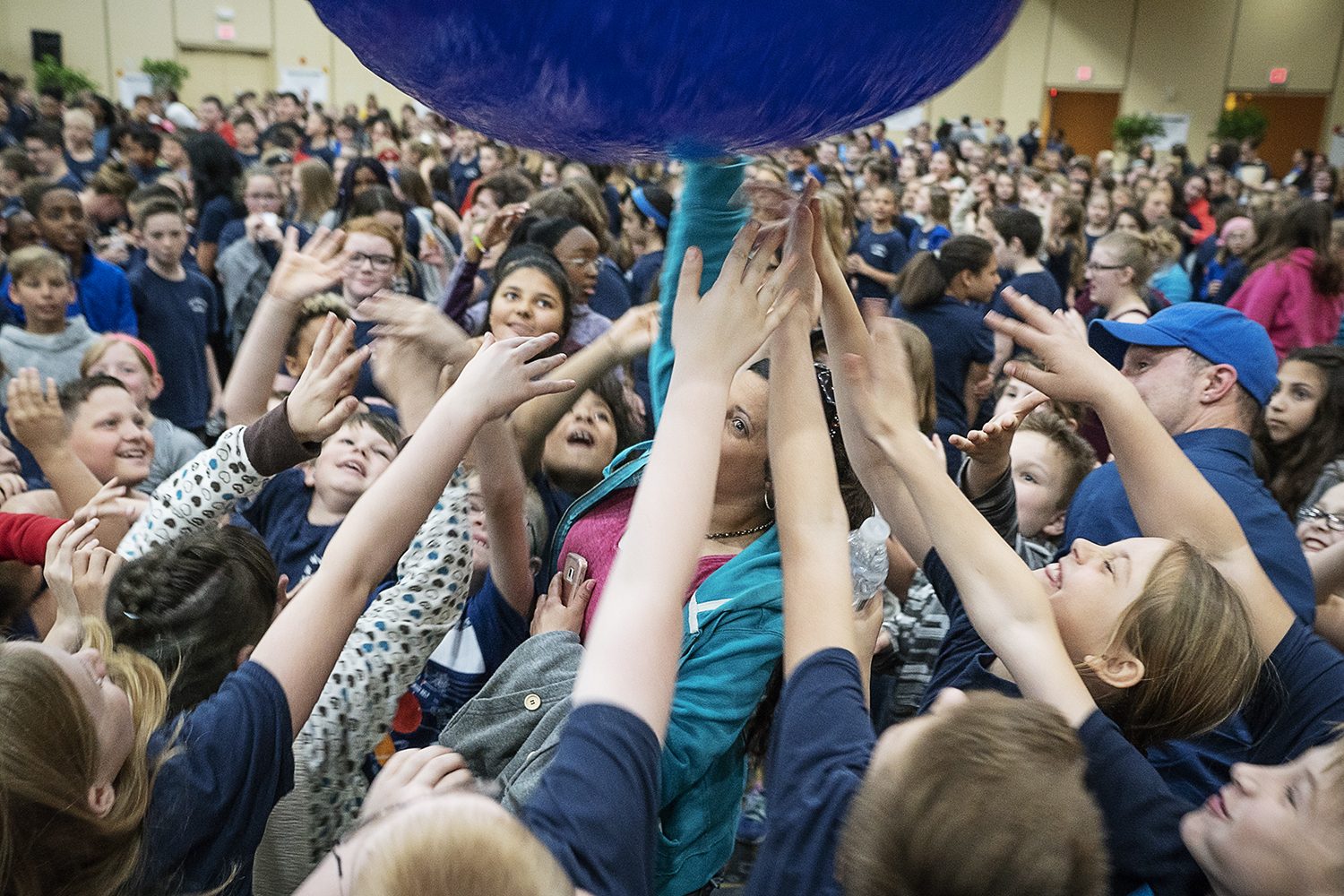 Flint, MI - Friday, May 4, 2018: Blueberry Ambassadors, teachers, and mentors bounce giant, inflated blueberries around the room before the beginning of the program for the 5th Annual Blueberry Ambassador Awards Party at the Riverfront Banquet Center