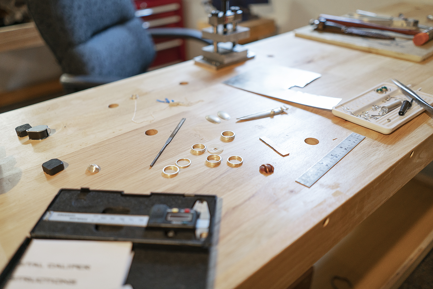 Flint, MI - Tuesday, May 8, 2018: Various pieces of unfinished jewelry and tools rest on a bench in the studio of metalsmith Robert McAdow.