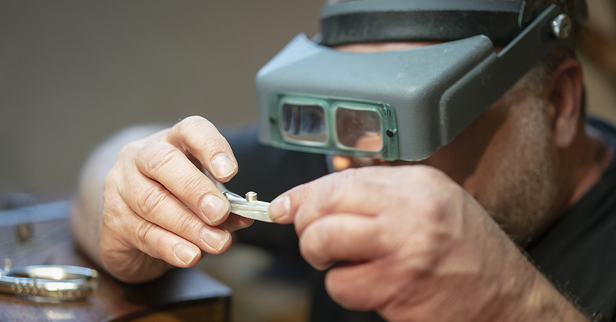 Flint, MI - Tuesday, May 8, 2018: Flint resident and metalsmith Robert McAdow inspects a setting in a pendant he is creating.